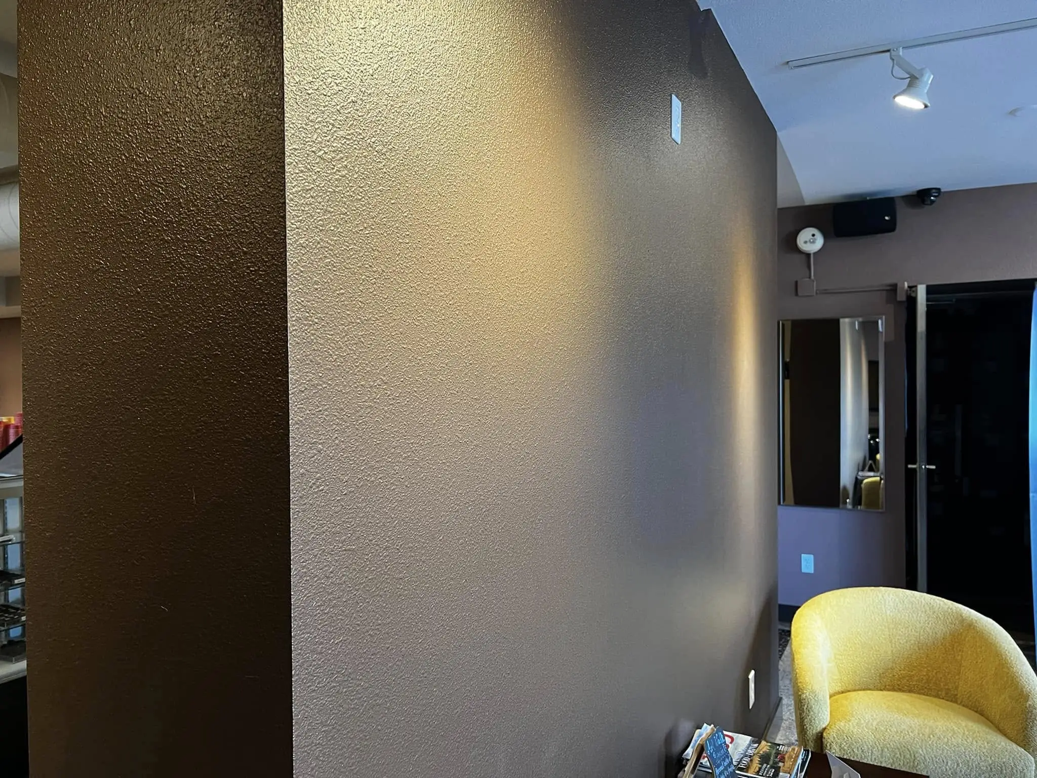 Finished commercial interior repaint at Chocolate Necessities in downtown Bellingham — custom chocolate tone plus metallic accent wall.